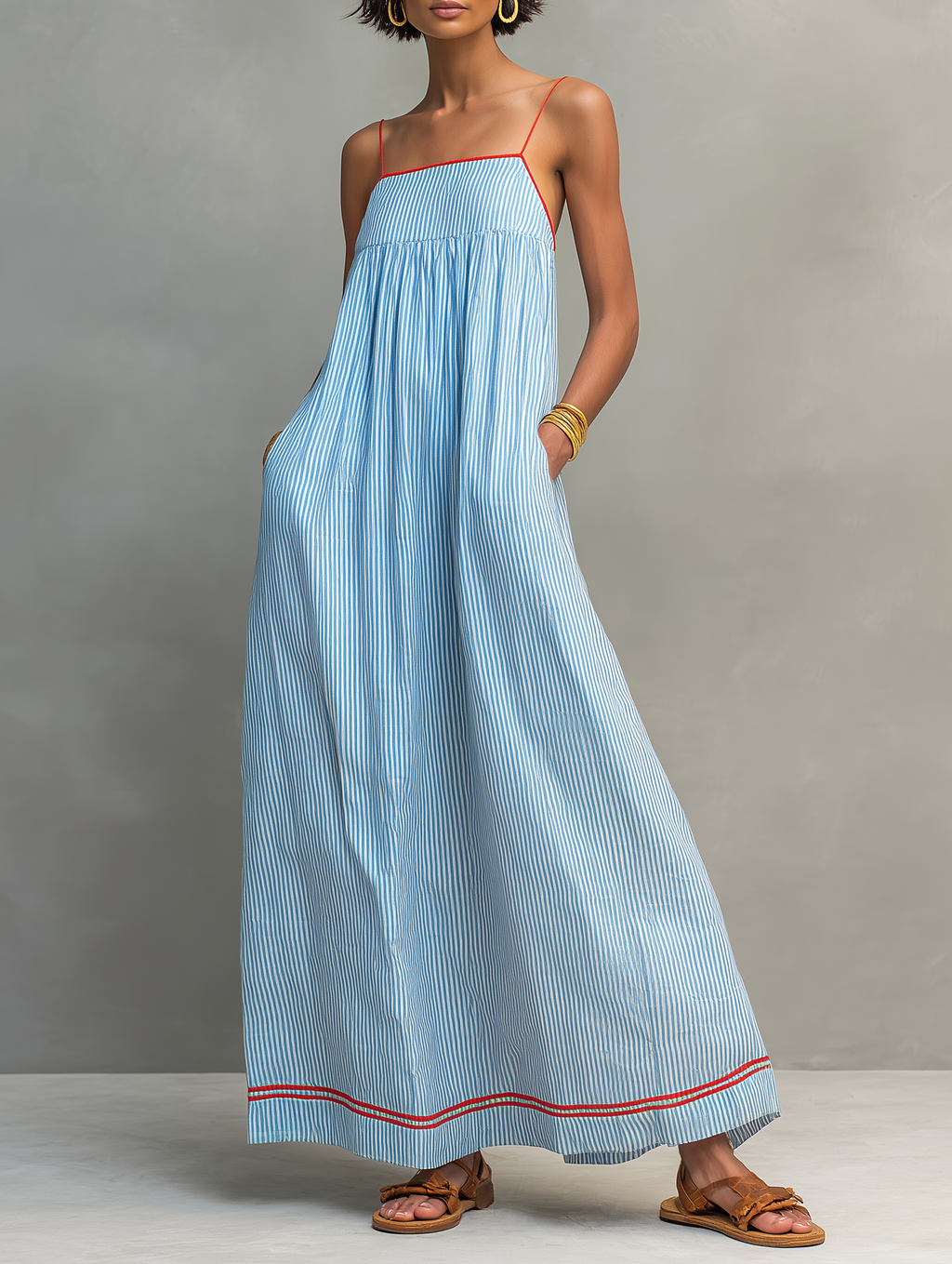 Blue striped maxi dress with spaghetti straps, gathered bodice, and red-trim hem