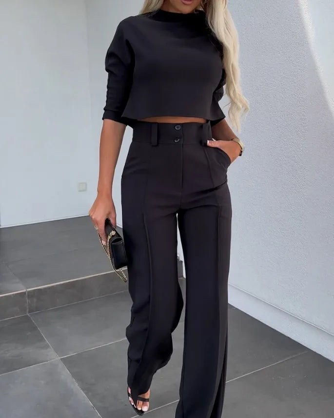 Black matching cropped top and high-waist wide-leg trousers with belt loops and front closure