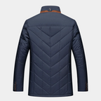 Men's blue quilted fall jacket back with chevron stitching and stand collar