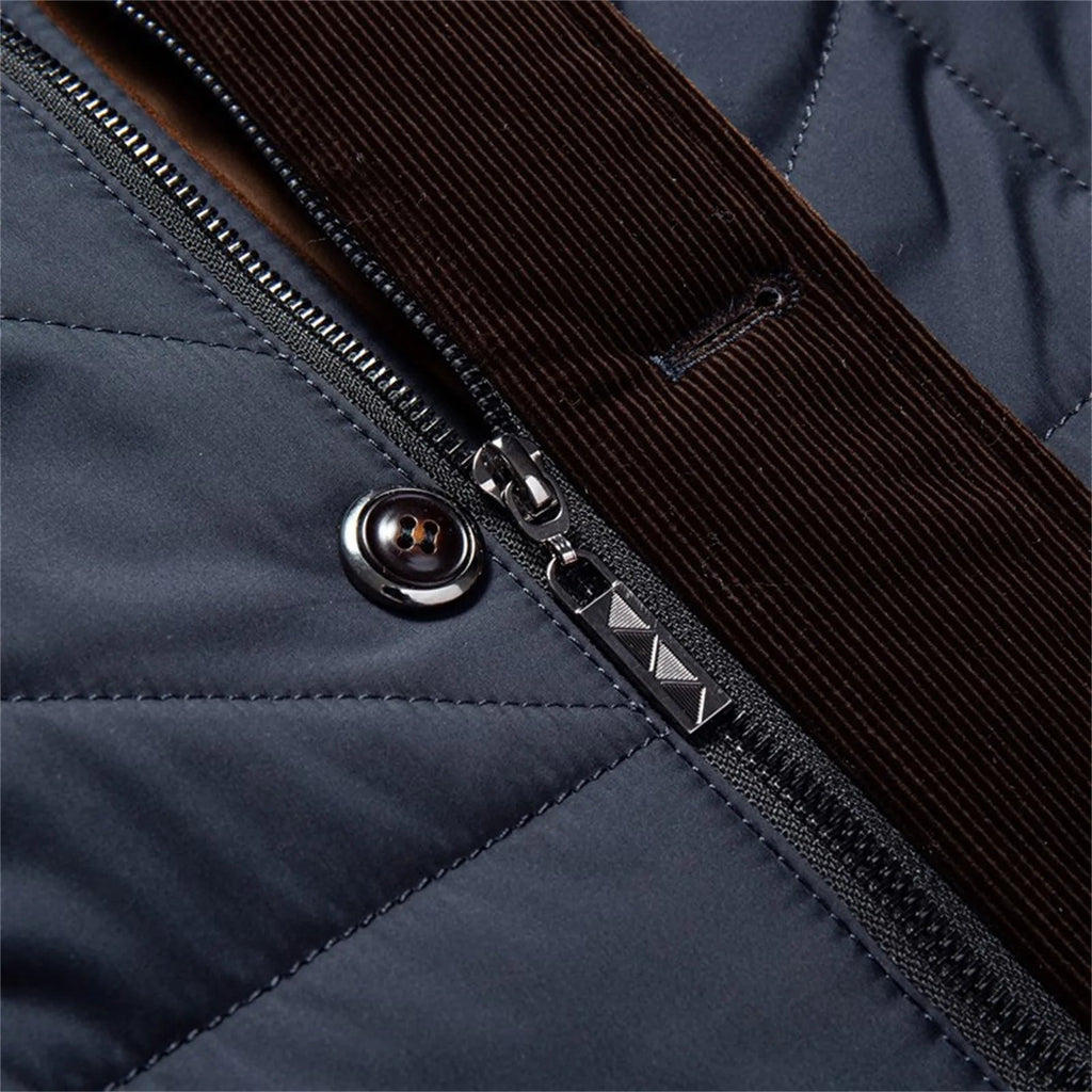 Blue quilted jacket zipper detail with metal pull and contrast stitched trim