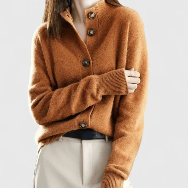 Rust brown knit cardigan with button front and long sleeves, ribbed cuffs.