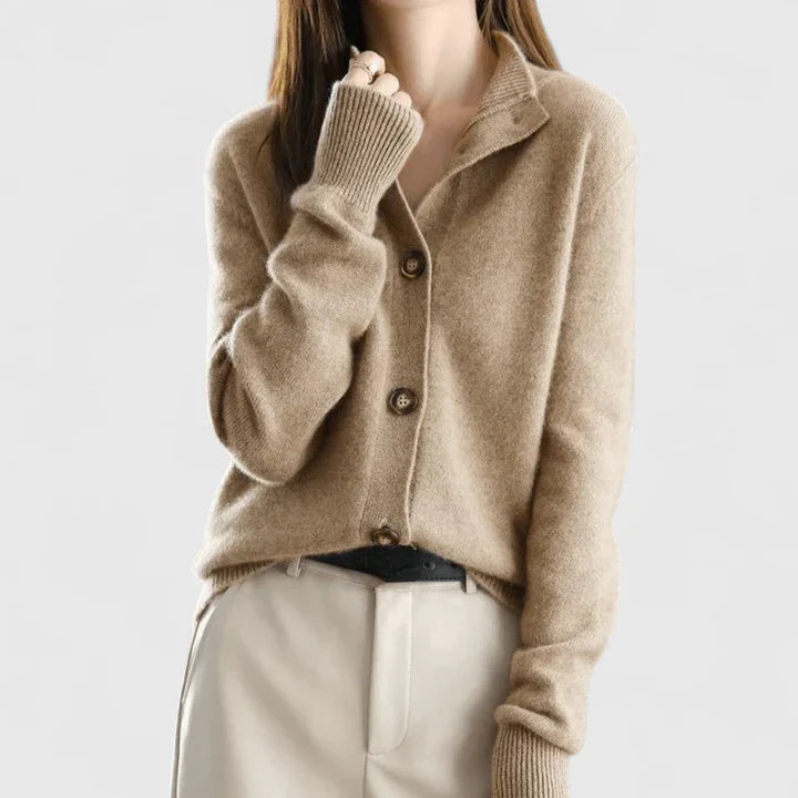 Beige knit cardigan with buttoned front, long sleeves, and ribbed cuffs.