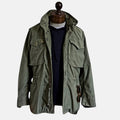 Green field jacket with four-button front and flap chest pockets
