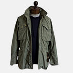 Green field jacket with four-button front and flap chest pockets