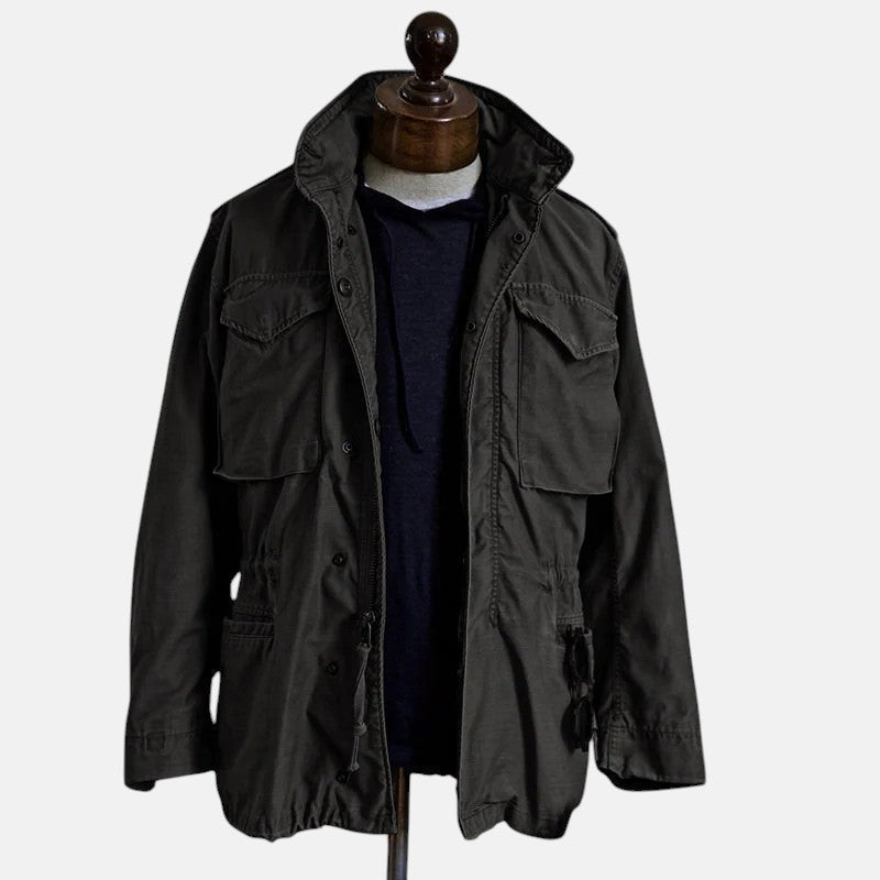 Black field jacket with flap chest pockets and button front