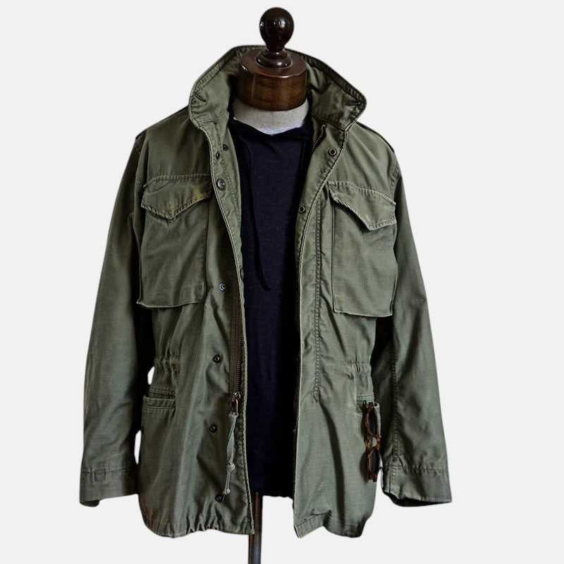 Green field jacket on mannequin with stand collar and flap pockets