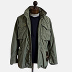 Green field jacket on mannequin with stand collar and flap pockets