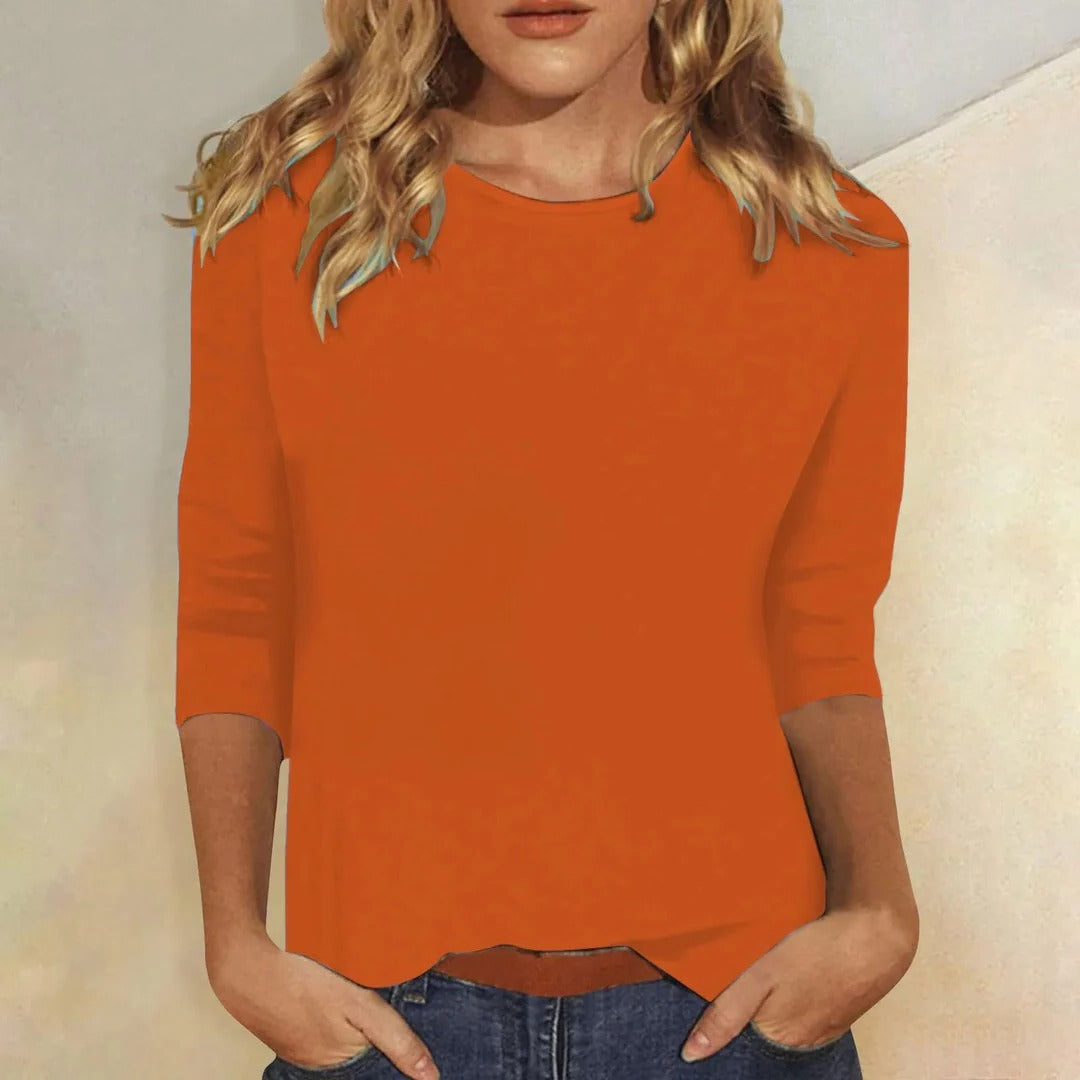Women’s solid crew neck top with three-quarter sleeves, relaxed straight fit, rust orange