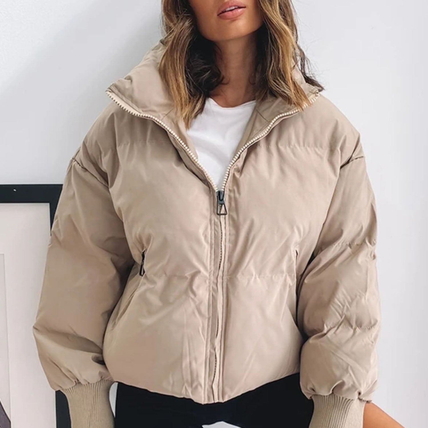 Beige cropped puffer jacket with full zip and ribbed cuffs