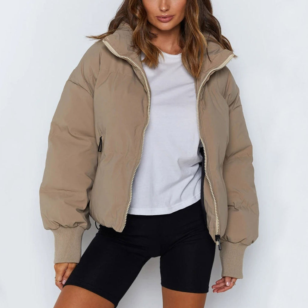 Beige short puffer jacket with hood, full front zipper, and ribbed hem