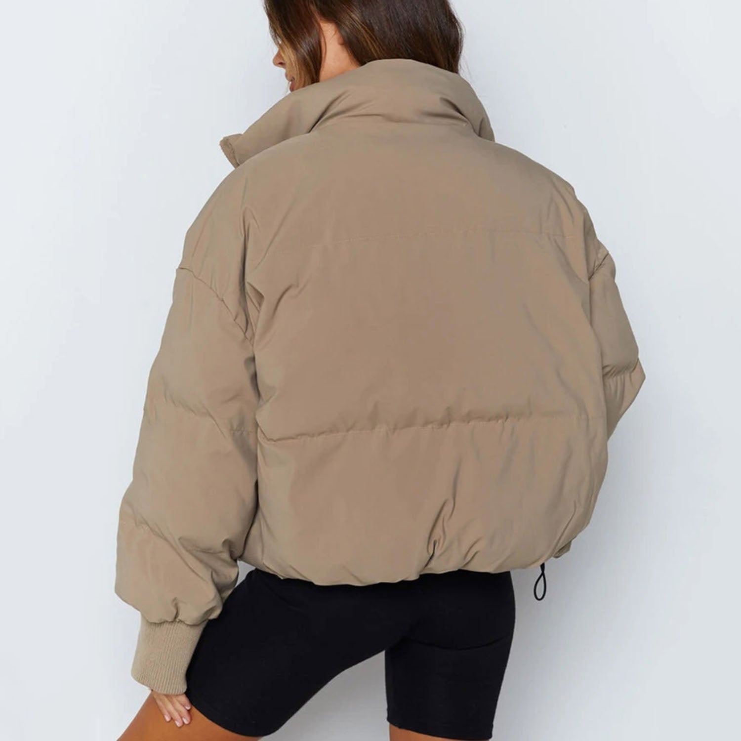 Beige puffer jacket back view with hood and ribbed cuff details