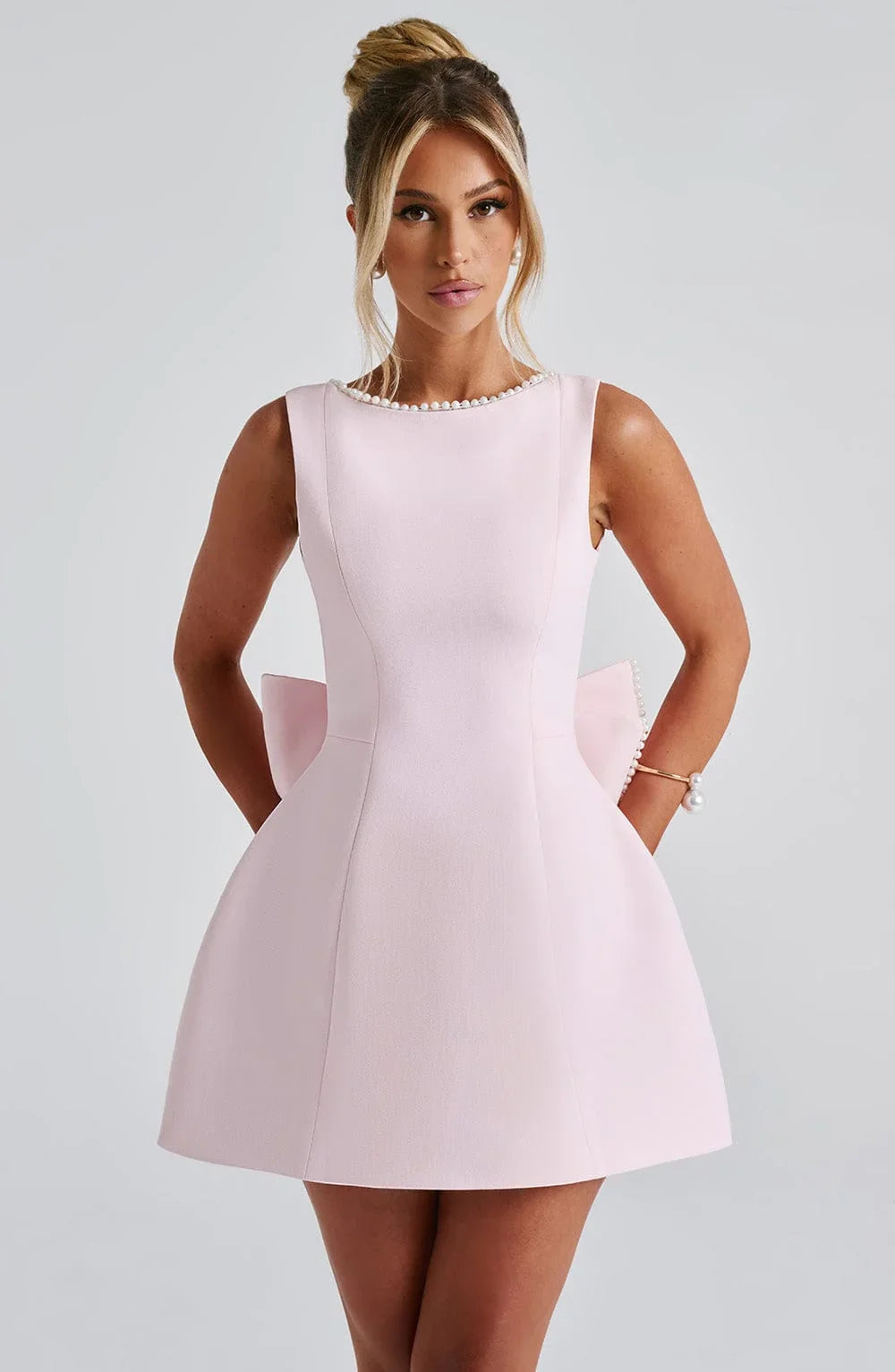 Sleeveless occasion mini dress in blush pink with pearl-trim neckline and fitted waist