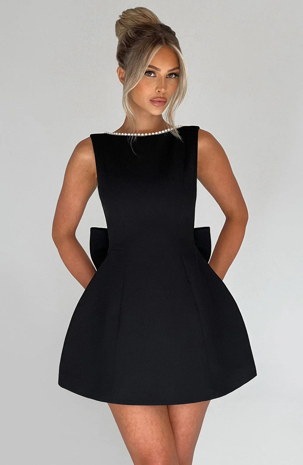 Sleeveless occasion mini dress in black with pearl-trim neckline
