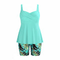Turquoise twist-front tankini top with tropical leaf bike shorts, two-piece set