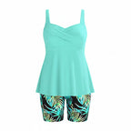 Turquoise twist-front tankini top with tropical leaf bike shorts, two-piece set