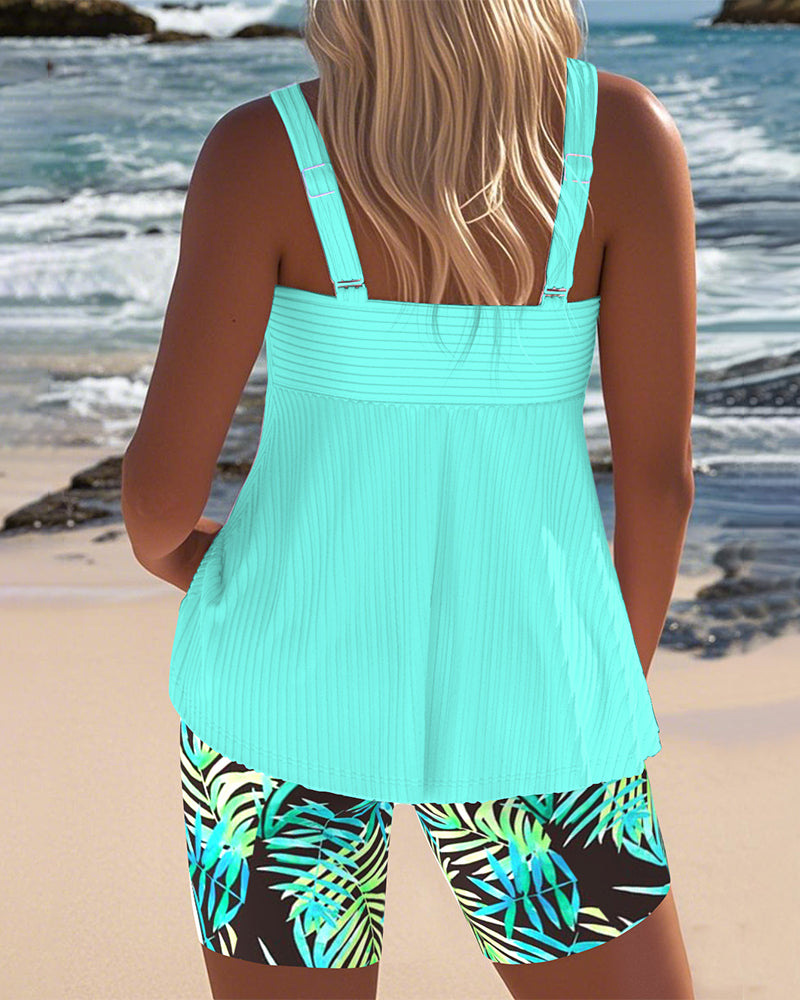 Cyan twist-front tankini top with matching tropical leaf bike shorts set