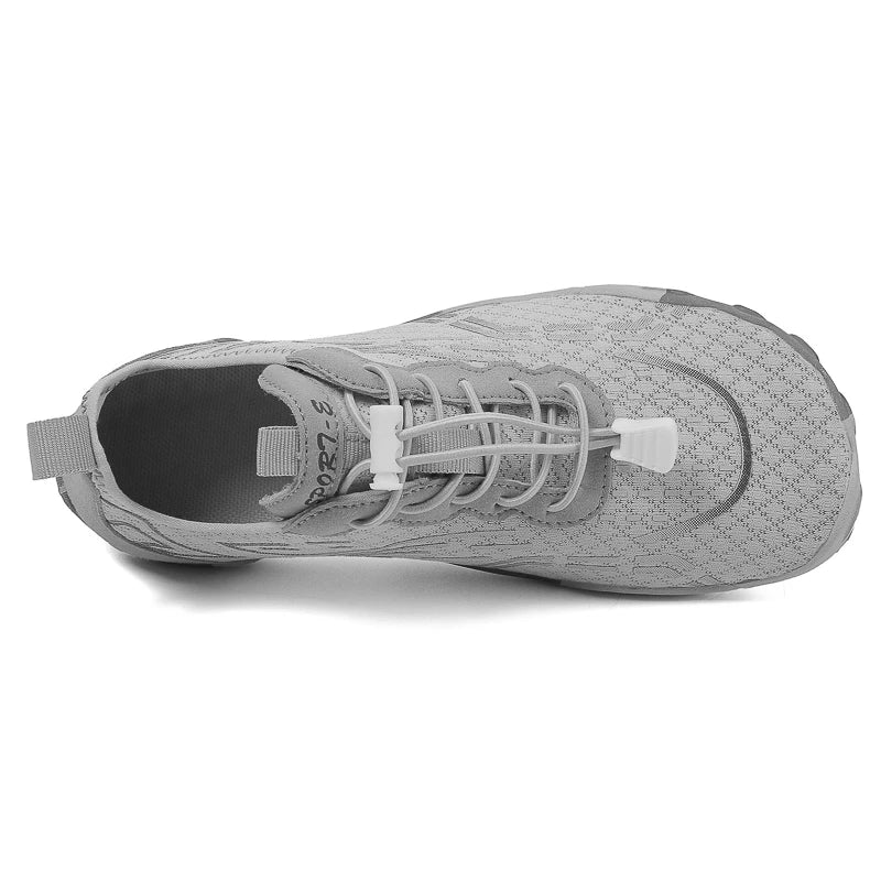 Gray low-top barefoot shoe side view with lace-up closure and flexible sole.