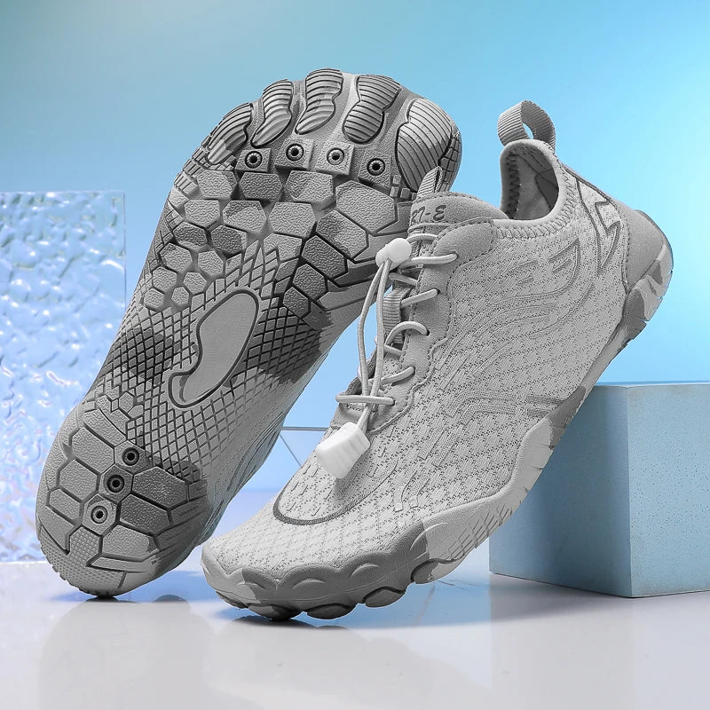 Light gray barefoot shoes with detailed traction outsole and lace-up upper.