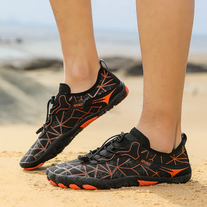 Black waterproof barefoot sneakers with orange geometric accents and grippy sole