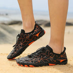 Black waterproof barefoot sneakers with orange geometric accents and grippy sole