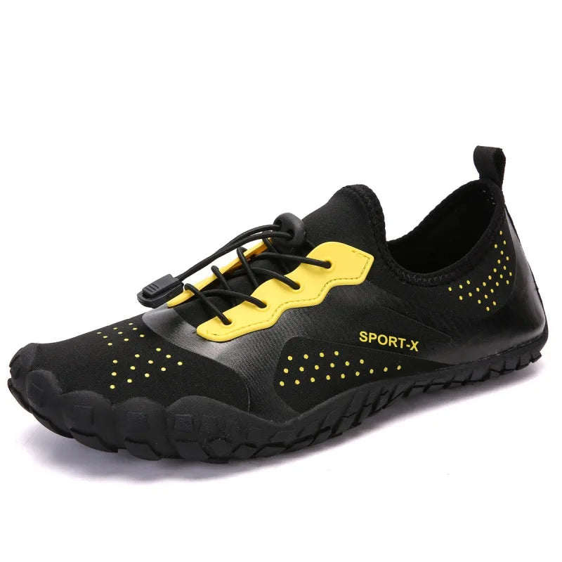 Unisex waterproof barefoot water shoe in black with yellow lace panel, perforations, rugged sole