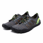 Grey water shoes with green laces and orange accents, slip-on athletic barefoot design
