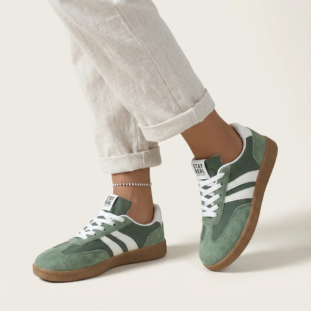 Women’s comfort lace-up sneakers in green with white stripes and gum sole