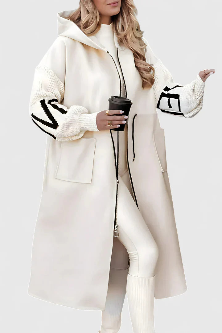 White hooded long coat with front zip, drawstring, and large patch pockets; graphic sleeves.