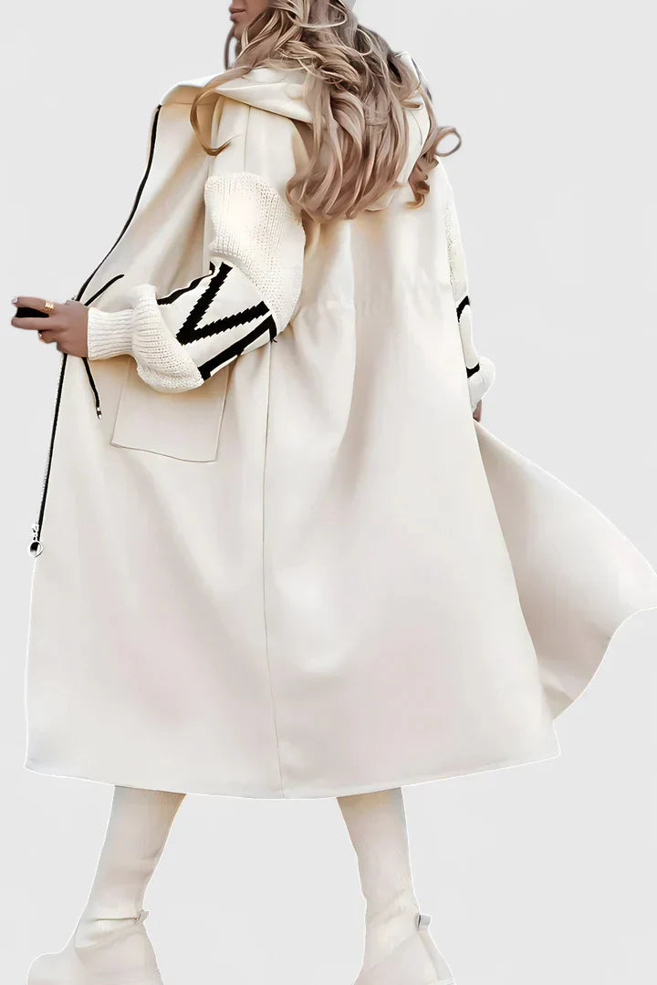 White hooded long coat with front zip, drawstring, and side patch pockets; graphic cuffs.