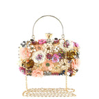 Floral embellished vegan leather clutch bag with gold-tone top handle and chain strap