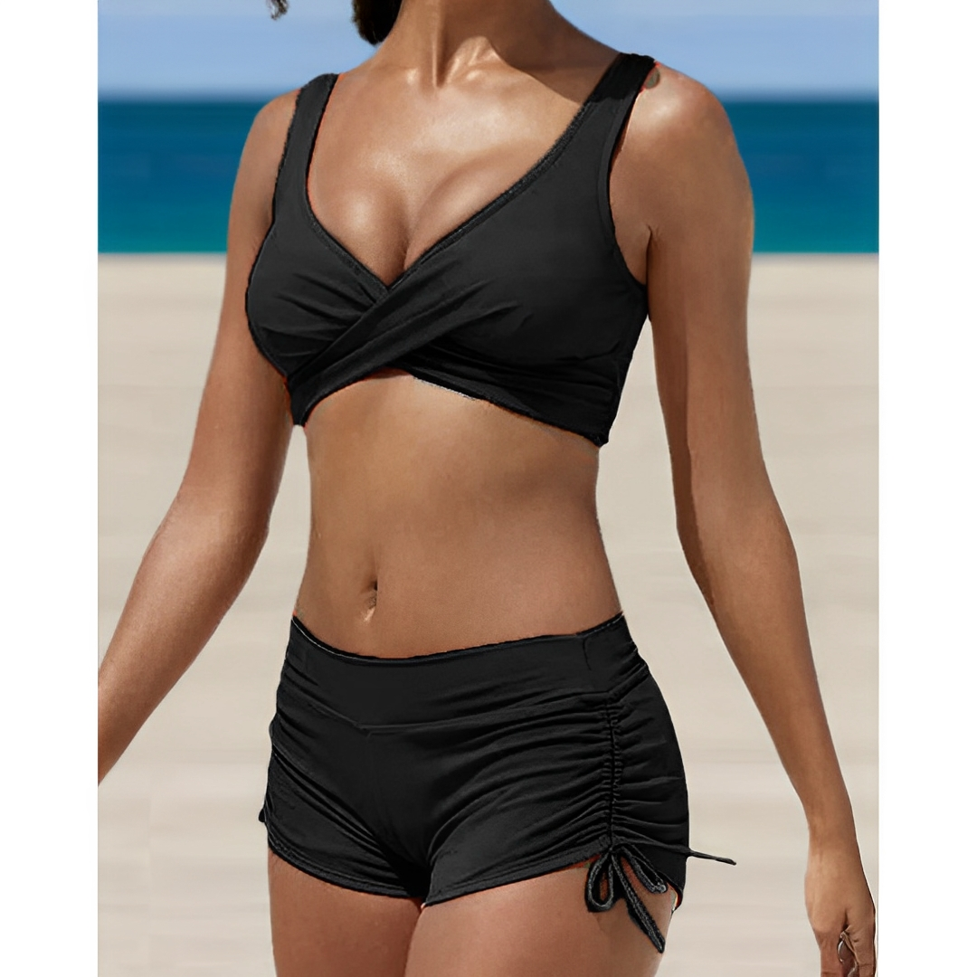 Black women's bikini two-piece with V-neck wrap top and ruched drawstring shorts