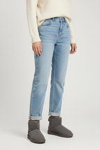 Women's grey ankle boots with faux fur lining worn with denim jeans