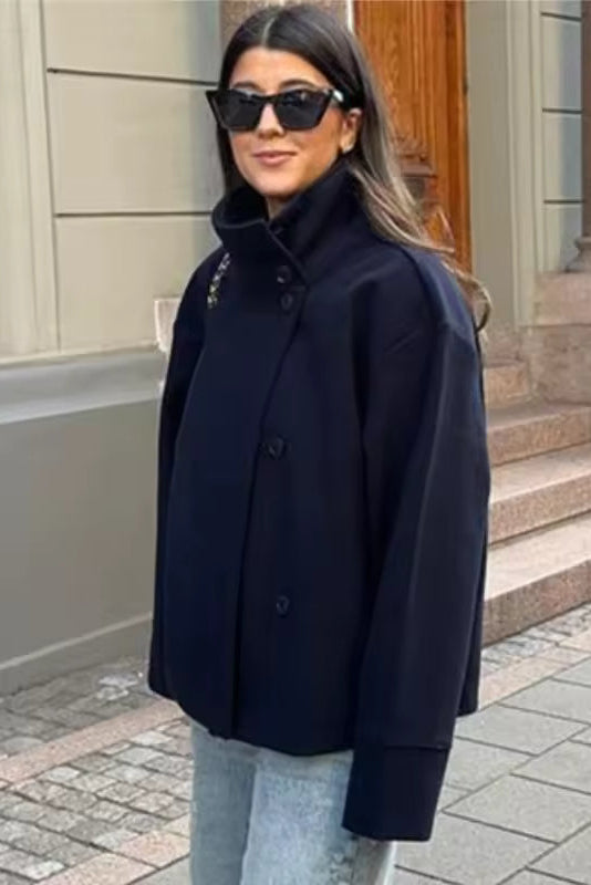 Women’s relaxed double-breasted winter coat in dark navy, structured shoulders, button front