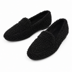 Black fleece-lined teddy slippers, slip-on moccasin style with textured grip sole