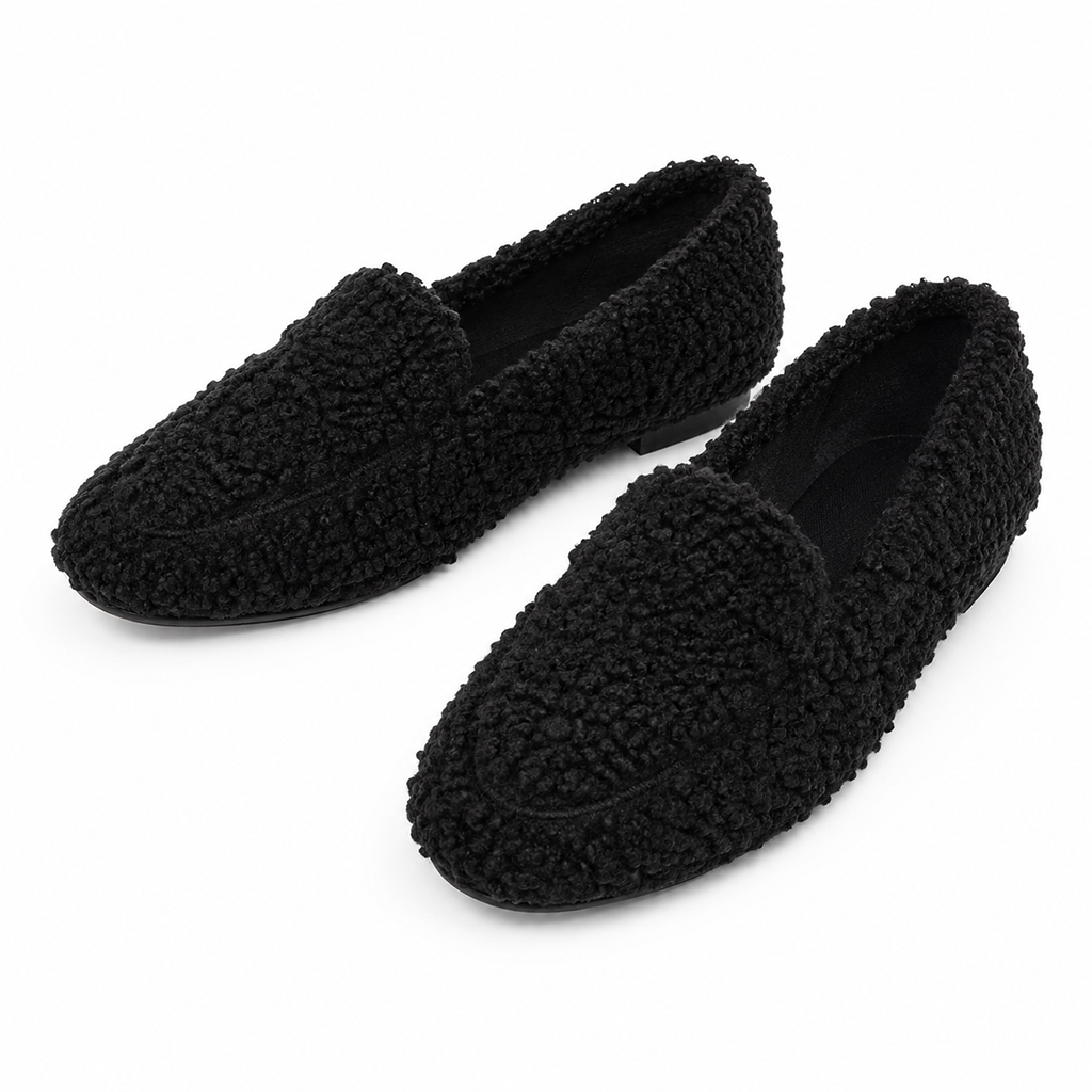 Black fleece-lined teddy slippers, slip-on moccasin style with textured grip sole