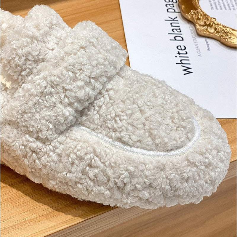 Close-up of women’s cream fleece teddy slip-on slipper with plush texture
