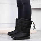 Black mid-calf quilted boots with side tassel, seam lines, and low-profile rubber sole