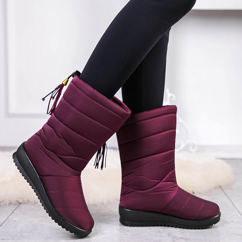 Burgundy mid-calf winter boots with quilted bands, tassel pull, and treaded rubber sole