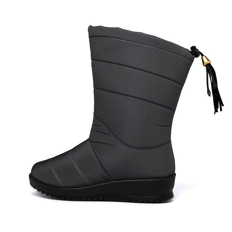 Dark grey mid-calf winter boots with quilted panel stitching and tassel pull