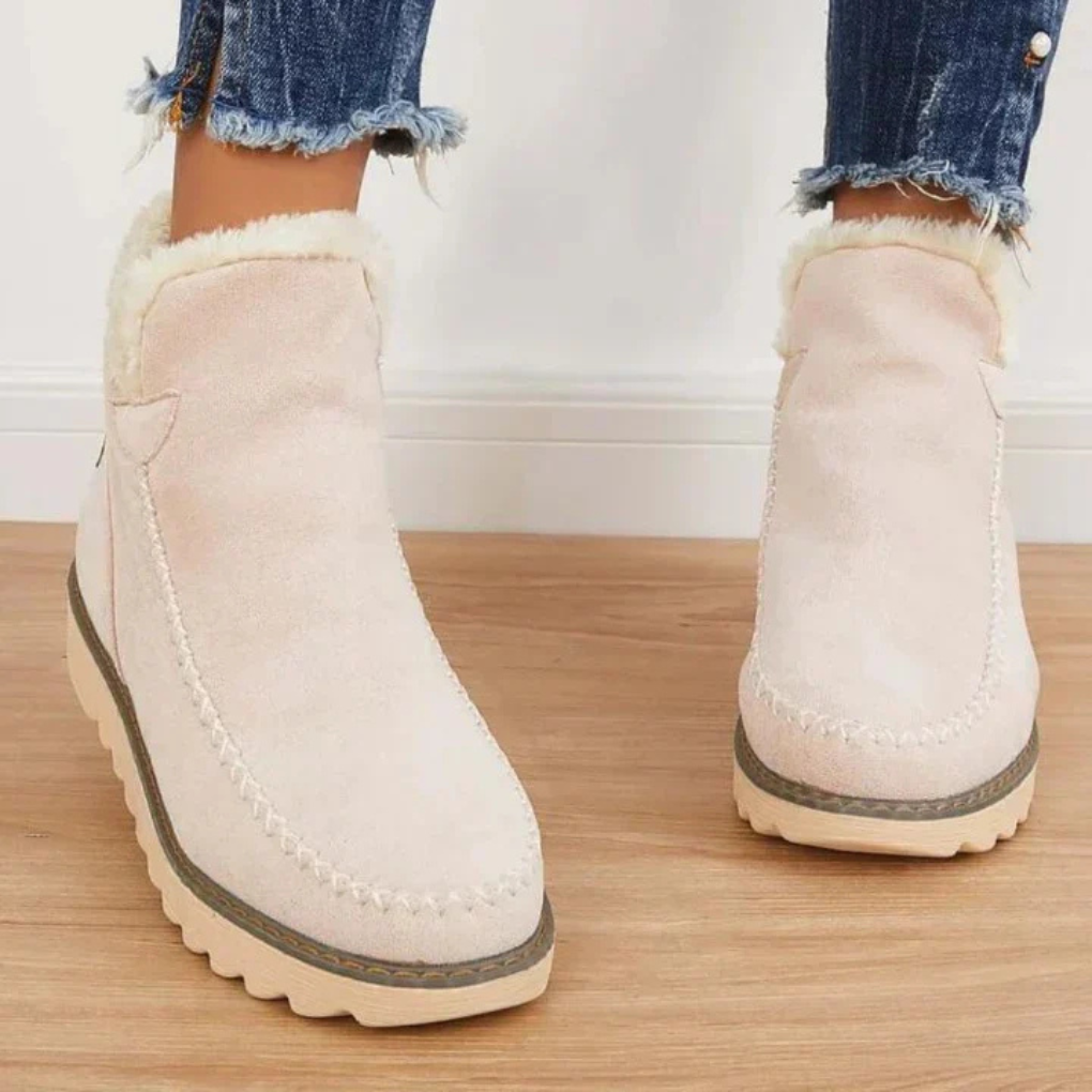 Beige slip-on winter boots with faux fur cuff and stitched moc toe