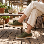 Green perforated slip-on walking shoes worn with textured flexible sole