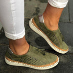 Women's slip-on walking shoes, green perforated side view with tassel detail
