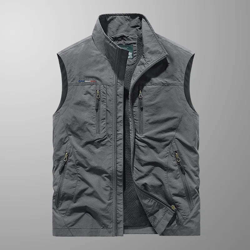 Gray cargo vest close-up with full-zip front, stand collar, and zip utility pockets