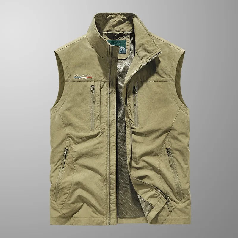 Khaki cargo vest close-up with full-zip front, stand collar, and zippered utility pockets