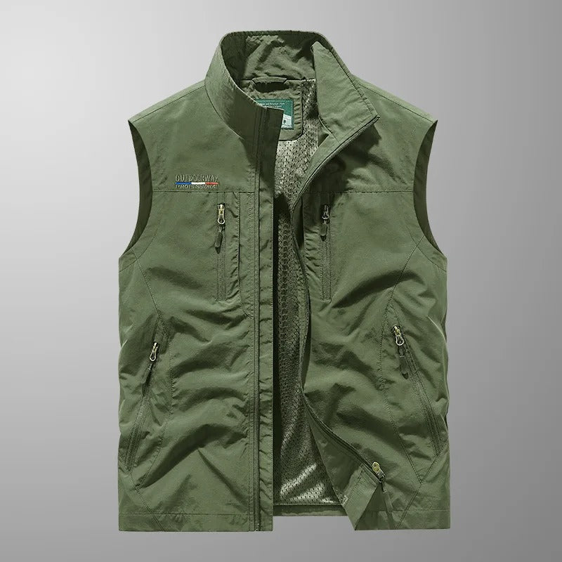 Green cargo vest close-up with full-zip front, stand collar, and zip utility pockets