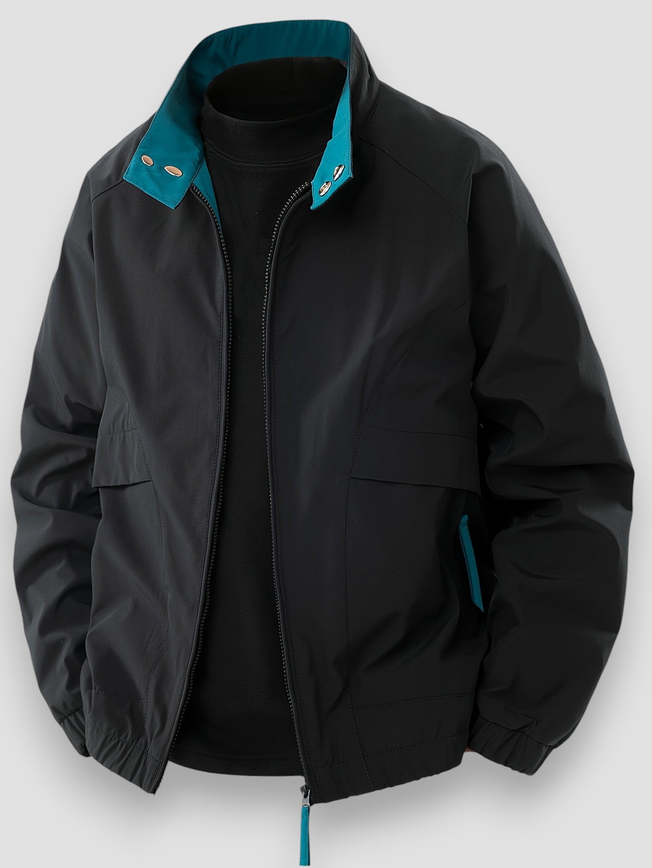 Black lightweight spring jacket with full-zip front, flap pockets, teal collar accents.