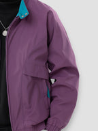 Purple lightweight spring jacket side view with full-zip front, snap pocket, and cuffed hem.