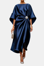 Navy satin maxi dress with wide short sleeves, boat neckline bow detail, draped skirt