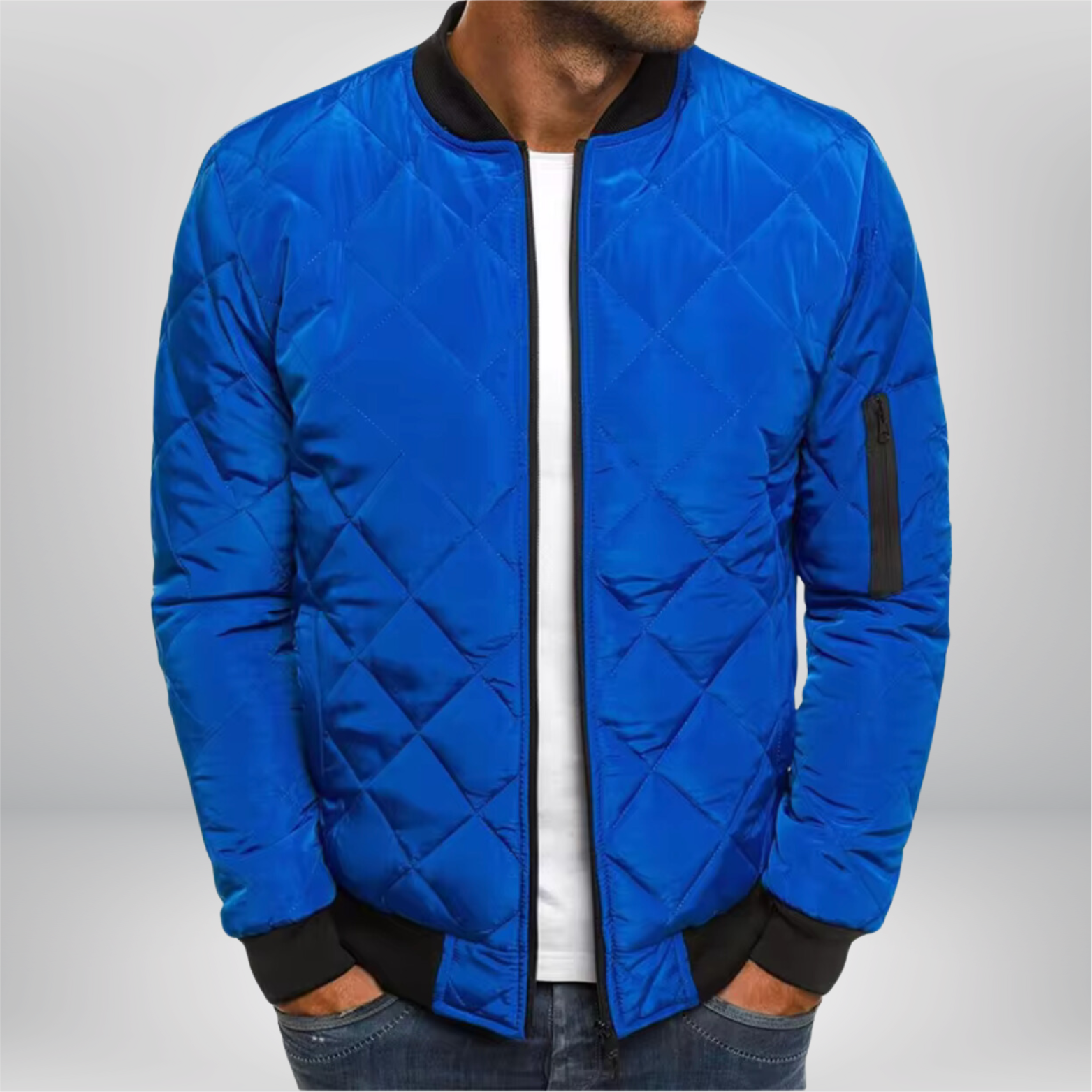Blue quilted bomber jacket with front zip, ribbed collar/cuffs, diamond quilting