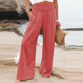 High-waisted linen wide-leg trousers with elastic smocked waistband, rust red